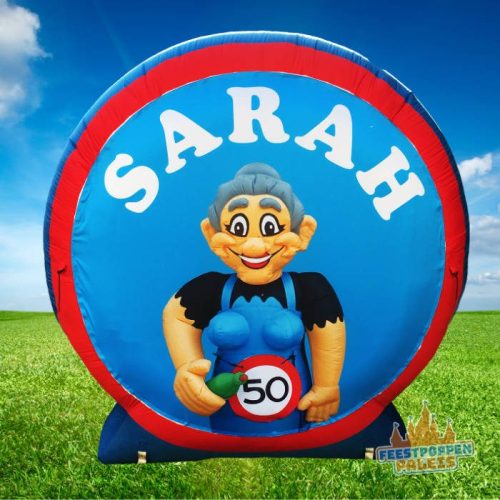 Vrolijk en opvallend feestbord ter ere van een 50-jarige Sarah! Met kleurrijk design en feestelijke elementen zoals ballonnen en slingers is dit bord perfect om in de tuin of voor het raam te plaatsen. Laat iedereen weten dat er een bijzondere mijlpaal wordt gevierd. Een leuke toevoeging aan het feest én een geweldige manier om de jarige in het zonnetje te zetten! 🥳